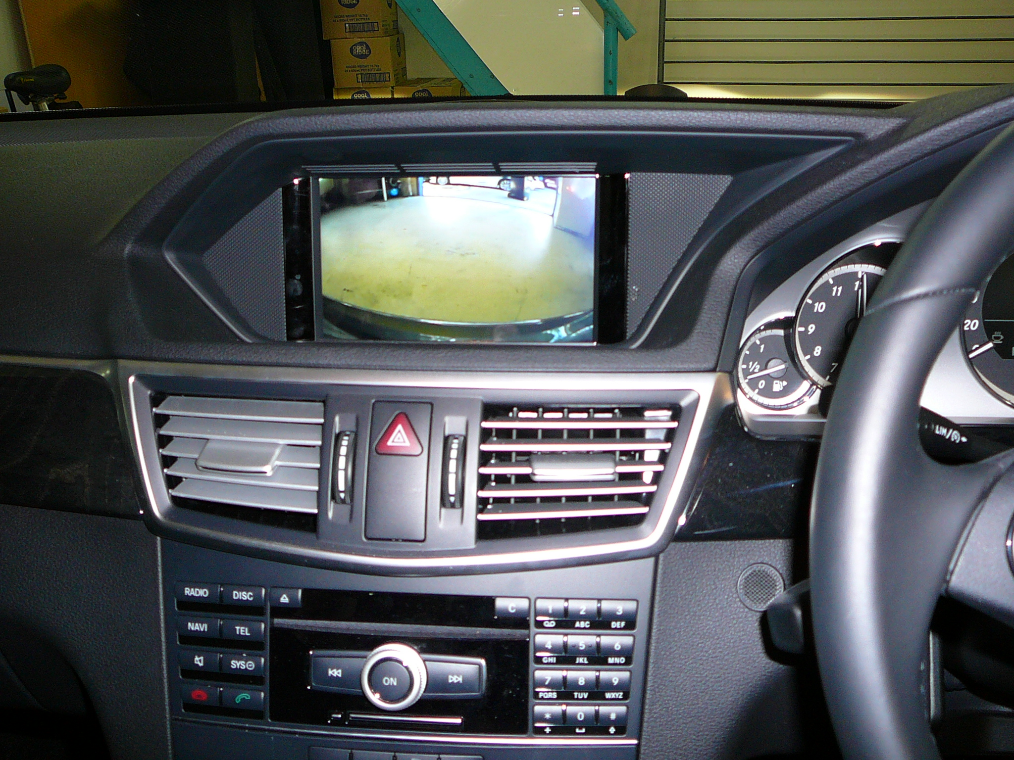 Mercedes Benz 2011 E Class with an aftermarket Reverse camera displayed on the factory screen.